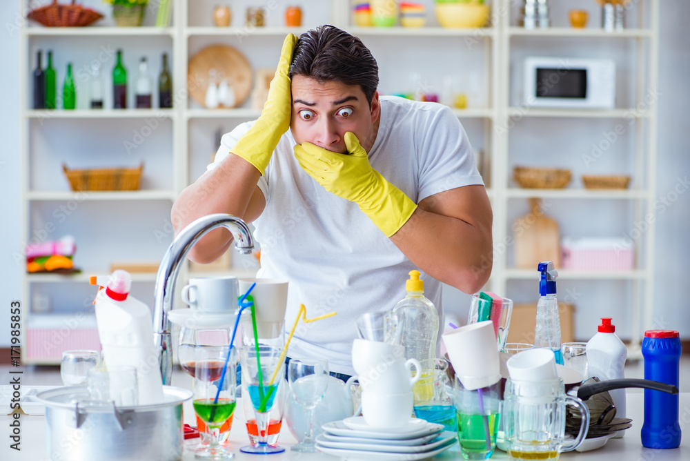 Man frustrated at having to wash dishes Man frustrated at having to wash dishes