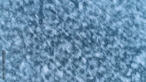 HD Frozen blue and white lake surface seen from above. Camera following snow mobile tracks on the ice. Blue abstract background. Winter and spring time in Kangasala. Finland. Scandinavia photo