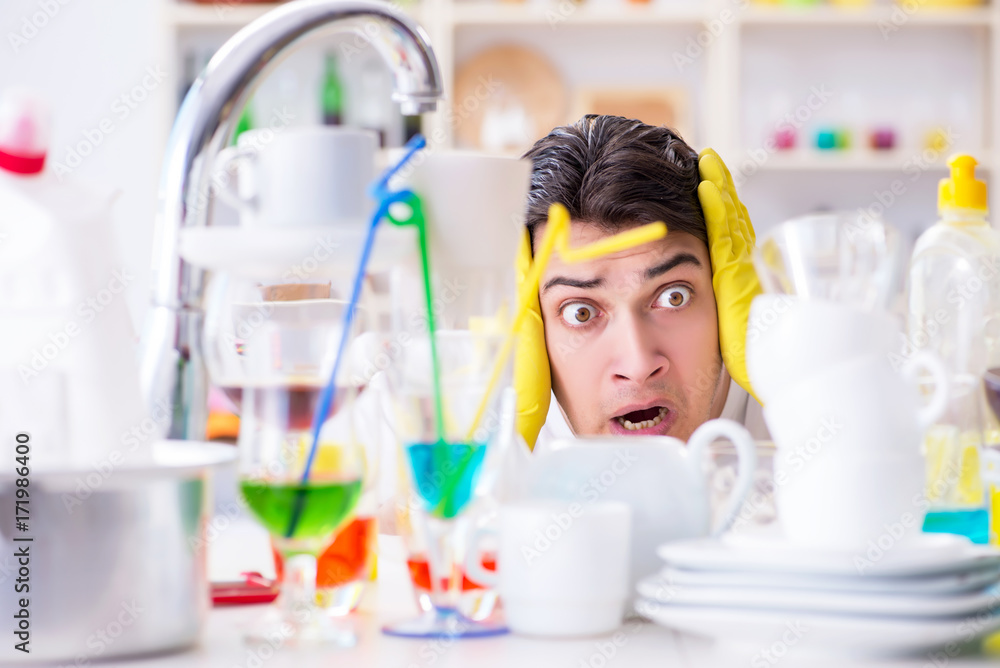 Man frustrated at having to wash dishes Man frustrated at having to wash dishes