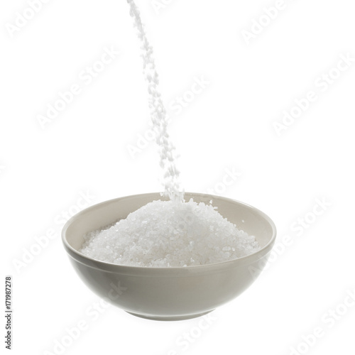 Pouring Sea Salt in Bowl Isolated   