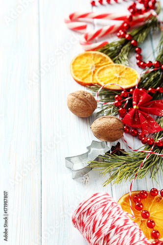 Christmas tree branch with dried oranges, anise star on wooden table