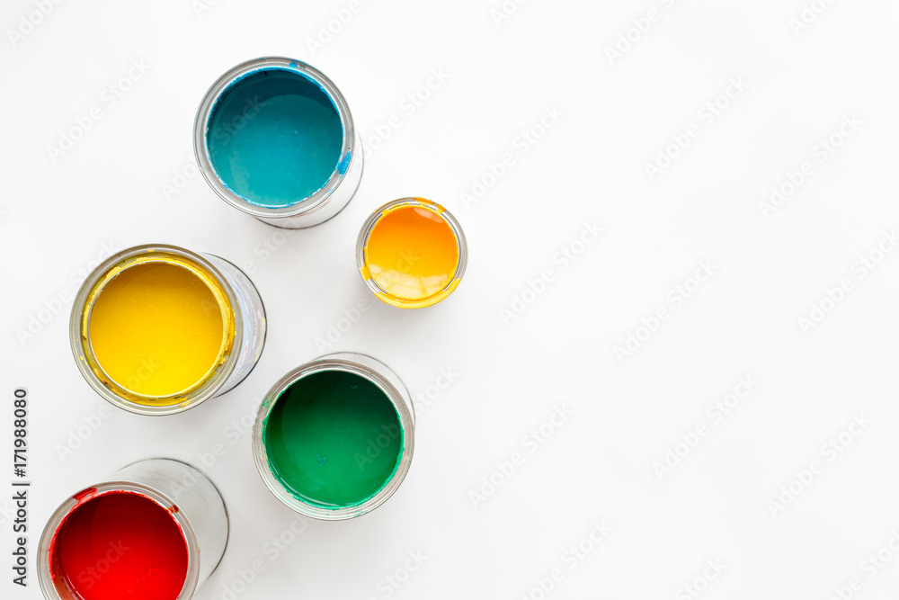 Paints in tin banks on white background top view copyspace Paints in tin banks on white background top view copyspace