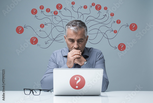 Photography Pensive businessman working with a laptop