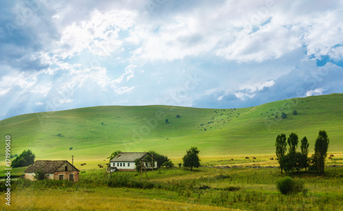 Big farm at the foot of green hills photo