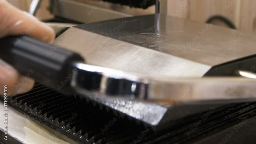 Closeup Chief Puts Hamburger on Roasting Machine Closeup Chief Puts Hamburger on Roasting Machine
