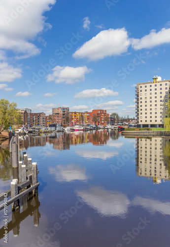 Apartment buildings with reflection in the water in Groningen