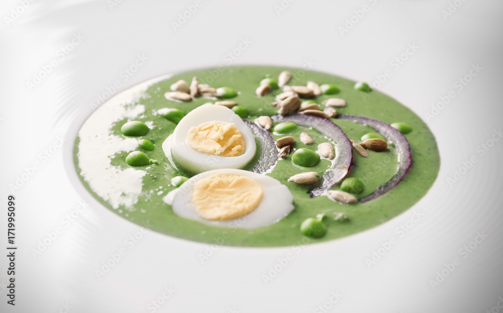 Plate with delicious puree from green peas, closeup