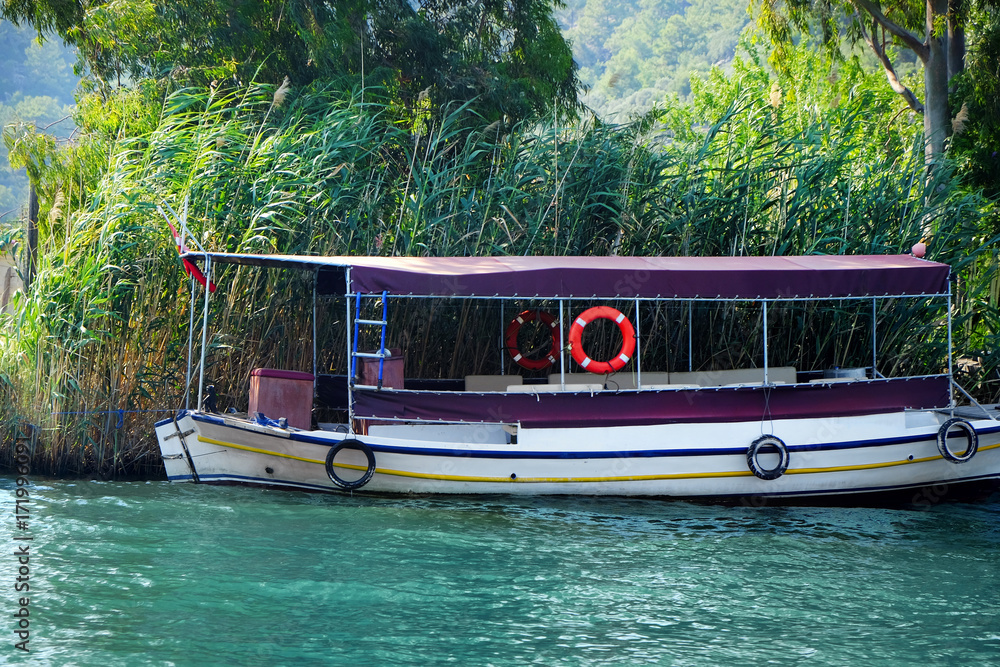Berthed boat on river in sunny summer day Berthed boat on river in sunny summer day