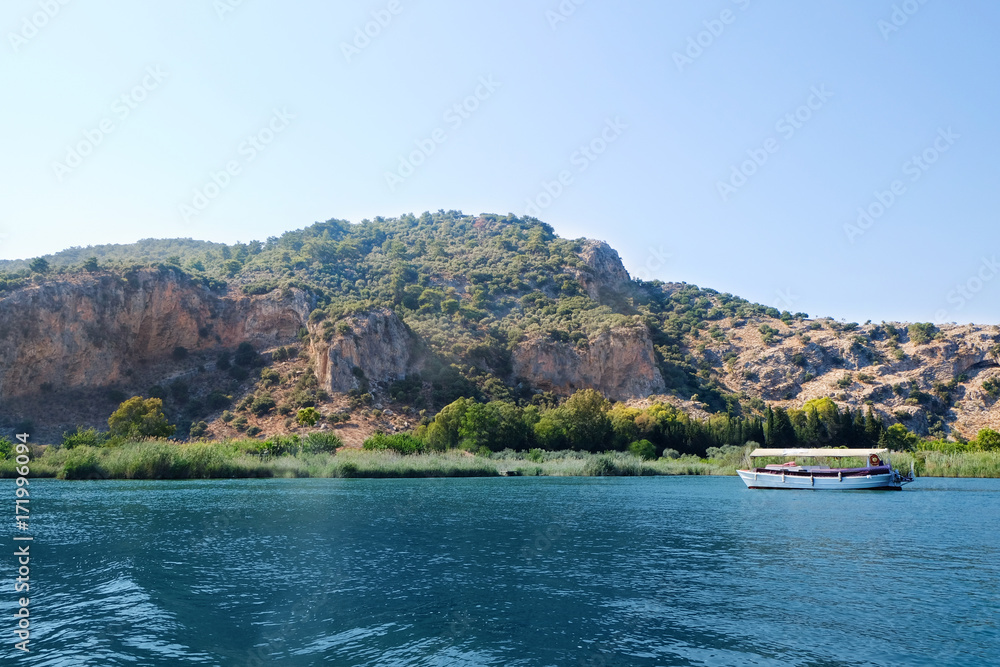 Amazing view of river and ancient Lycian rock tombs on sunny summer day