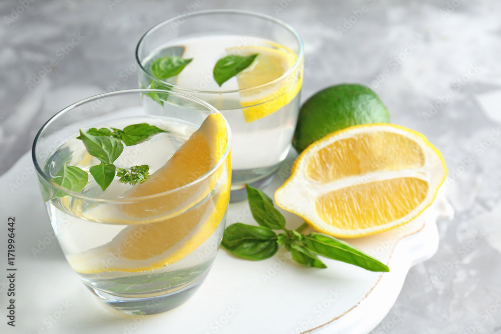 Board with glasses of basil water on table Board with glasses of basil water on table
