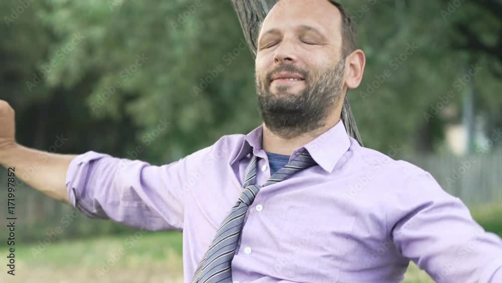 Young businessman finish working on laptop and relaxing sitting on grass in park
Young businessman finish working on laptop and relaxing sitting on grass in park