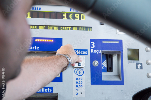 A man pays tolls on the highway