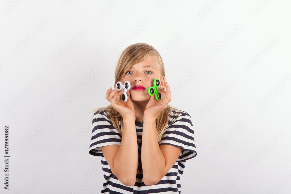 Girl playing with two fidget spinners Girl playing with two fidget spinners