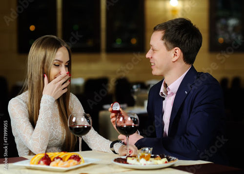 guy doing the girl a marriage proposal in the restaurant