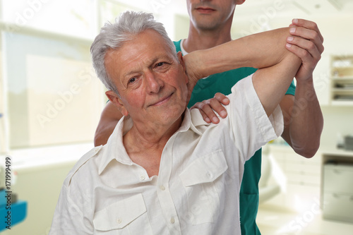 Man having chiropractic back and arm adjustment. Osteopathy, Alternative medicine, pain relief concept. Physiotherapy, sport injury rehabilitation