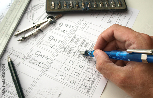 engineer working on a structure fundation design blueprint photo