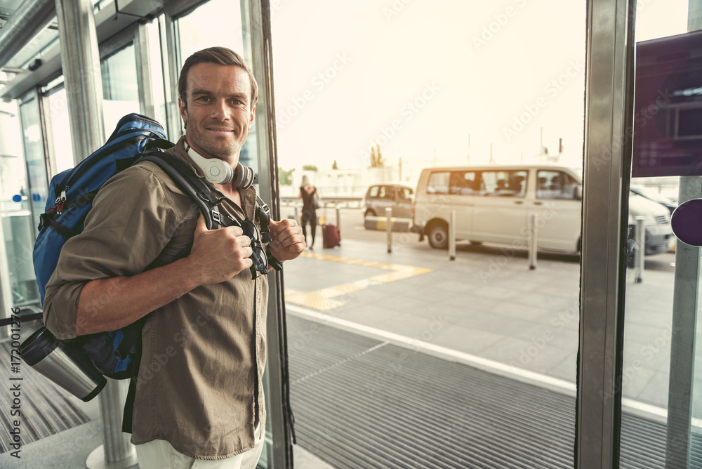 Cheerful guy is going out of doors Cheerful guy is going out of doors