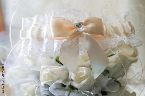 beautiful white bride's garter with flowers