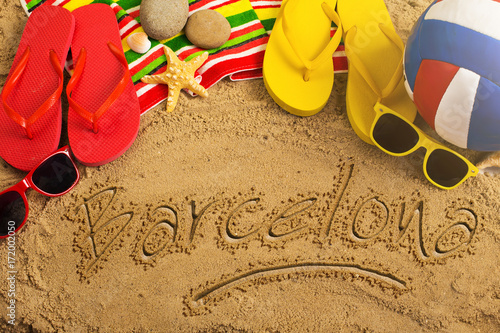 Photography Summer concept of sandy beach, colorful thongs shoes, sunglasses, ball and inscription