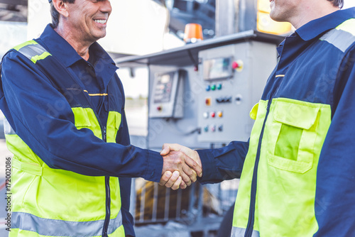 Cheerful male worker greeting with partner