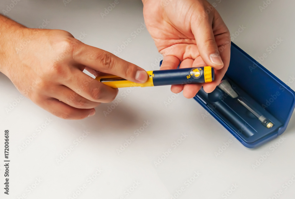 A man holds a syringe for subcutaneous injection of hormonal drugs in the IVF protocol (in vitro fertilization). Medical product in ampoules. Preparation for pregnancy. Helping Wife A man holds a syringe for subcutaneous injection of hormonal drugs in the IVF protocol (in vitro fertilization). Medical product in ampoules. Preparation for pregnancy. Helping Wife