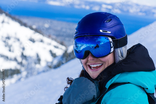 Close up of smiling caucasian woman on snowboard in snowy mountains © Jeremy Francis