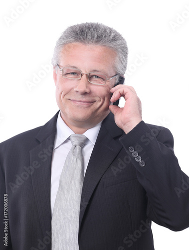 Portrait of smiling senior businessman standing against white