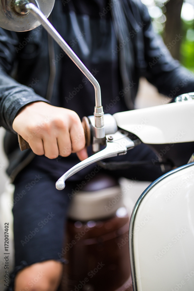 Riding motorcycle, close up of hand on handlebar of scooter