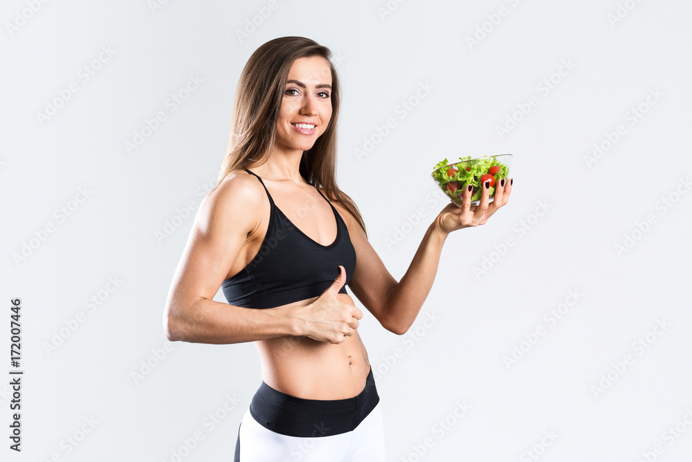 Beautiful sports girl with salad isolated. Beautiful sports girl with salad isolated.