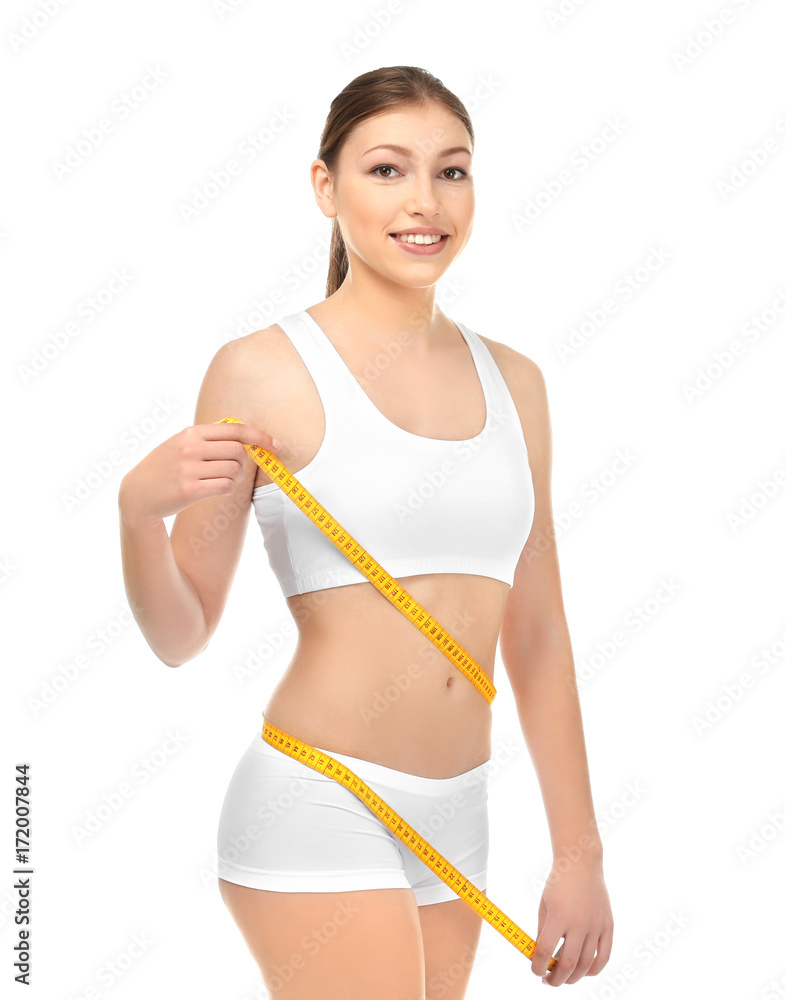 Beautiful young woman in underwear with measuring tape on white background. Diet concept