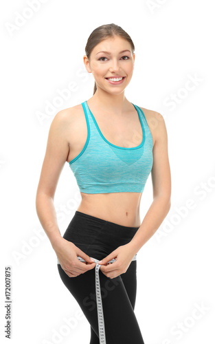 Beautiful young woman with measuring tape on white background. Diet concept © Africa Studio