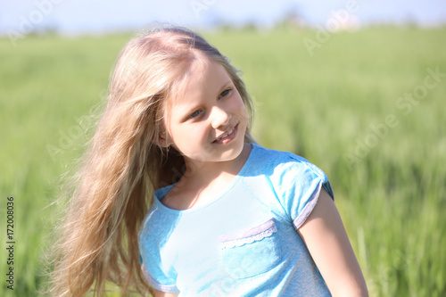 Little girl in green field