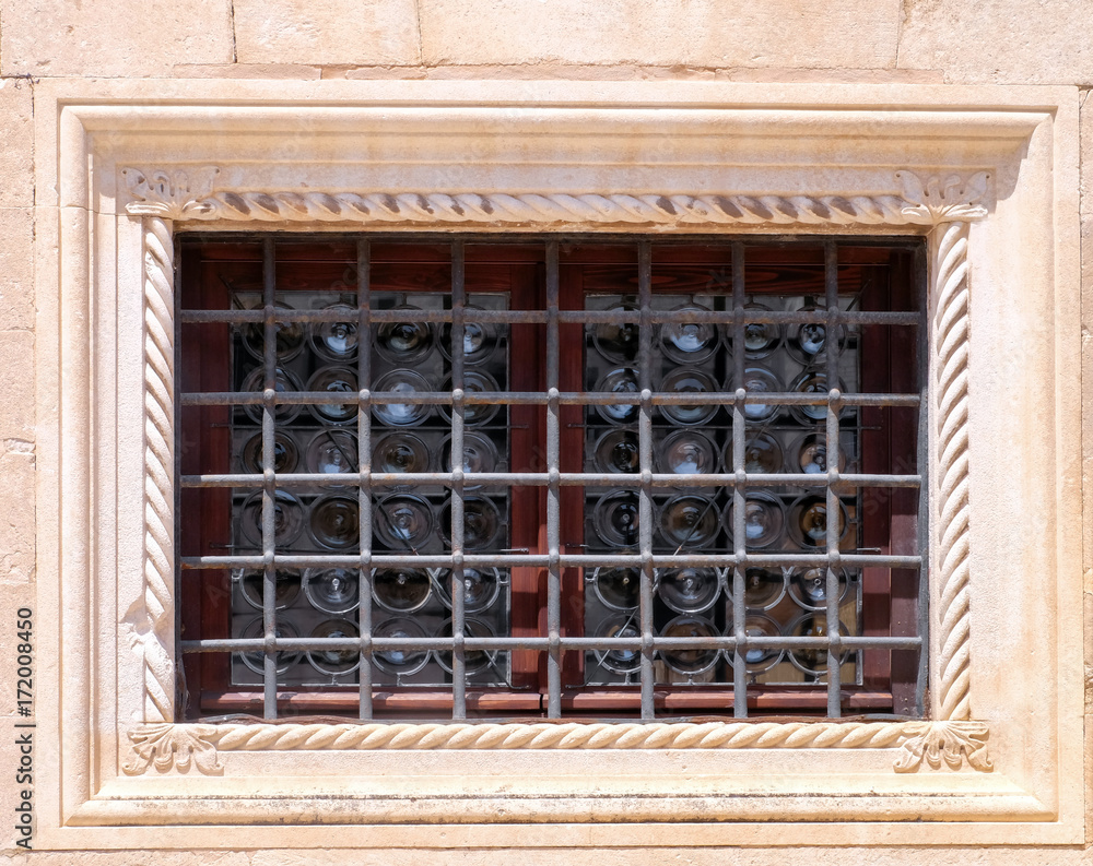Vintage window with lattice of old stone house