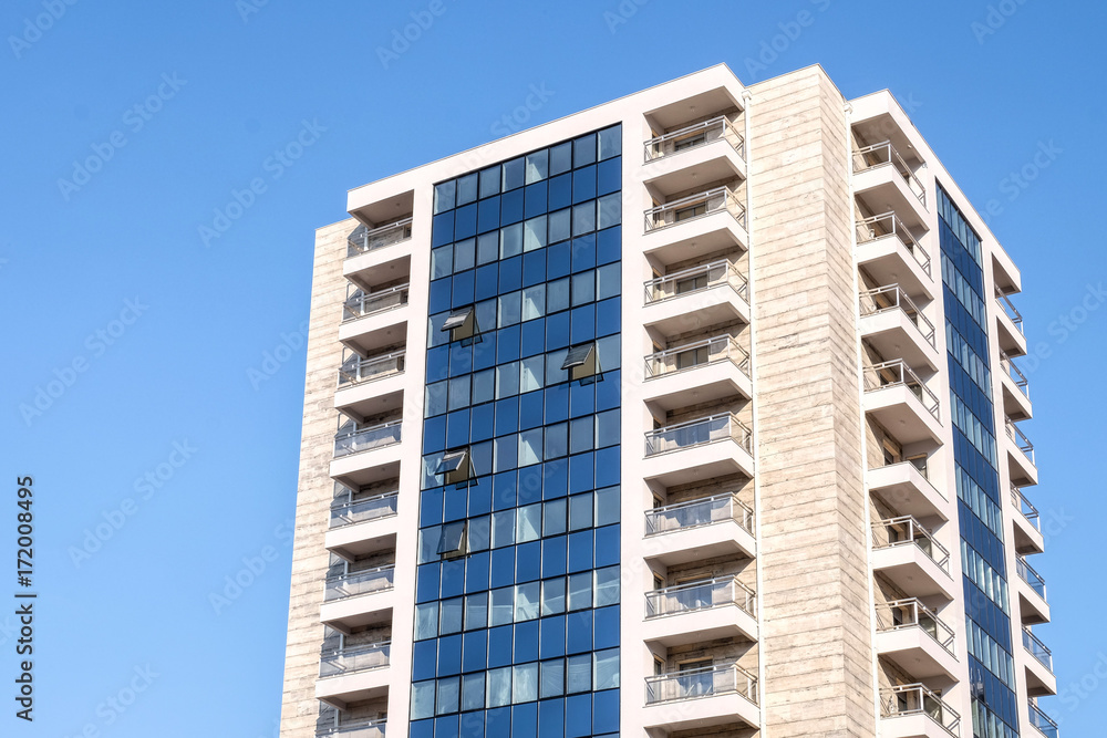 Tall building on blue sky background