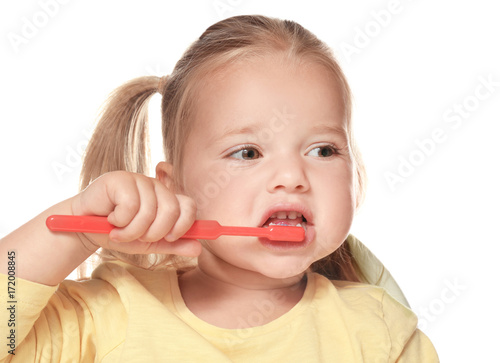 Cute little girl brushing teeth, isolated on white