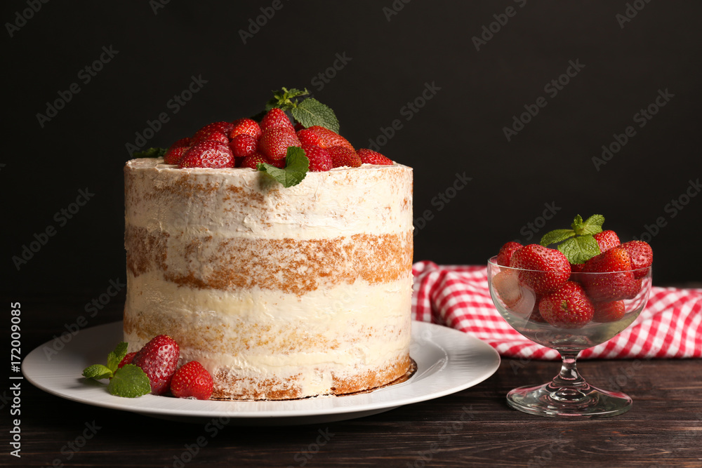 Delicious strawberry cake on wooden table Delicious strawberry cake on wooden table