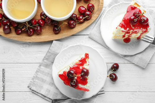 Fototapeta Naklejka Na Ścianę i Meble -  Plates with pieces of delicious cherry cake on table