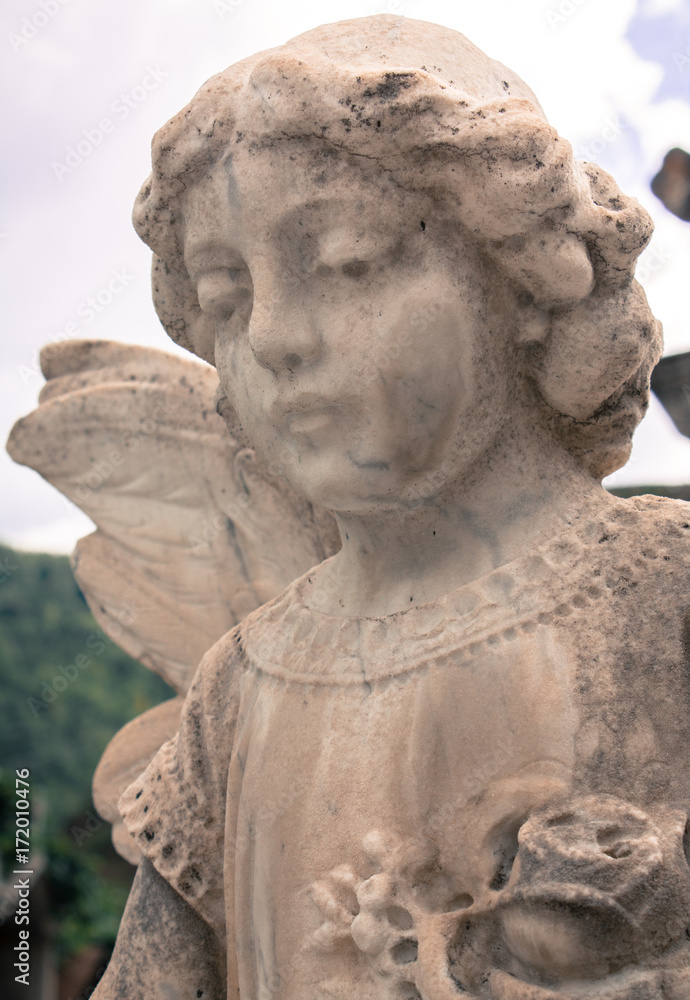 Statue of a baby angel looking down