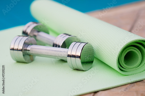 Two dumbbells and yoga mat