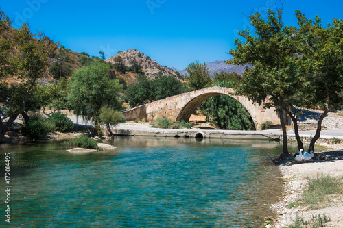 Panorama of kourtaliotis river and a stone arch bridge at Preveli, Crete, Greece