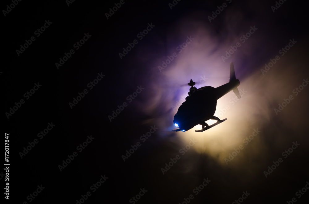 Helicopter over fire sunset horizon. War concept. Military scene of flying helicopter fire backgroung effect. Decoration