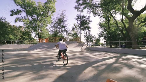 Wallpaper Mural BMX rider doing tricks in extreme park during sunset, slow motion Torontodigital.ca