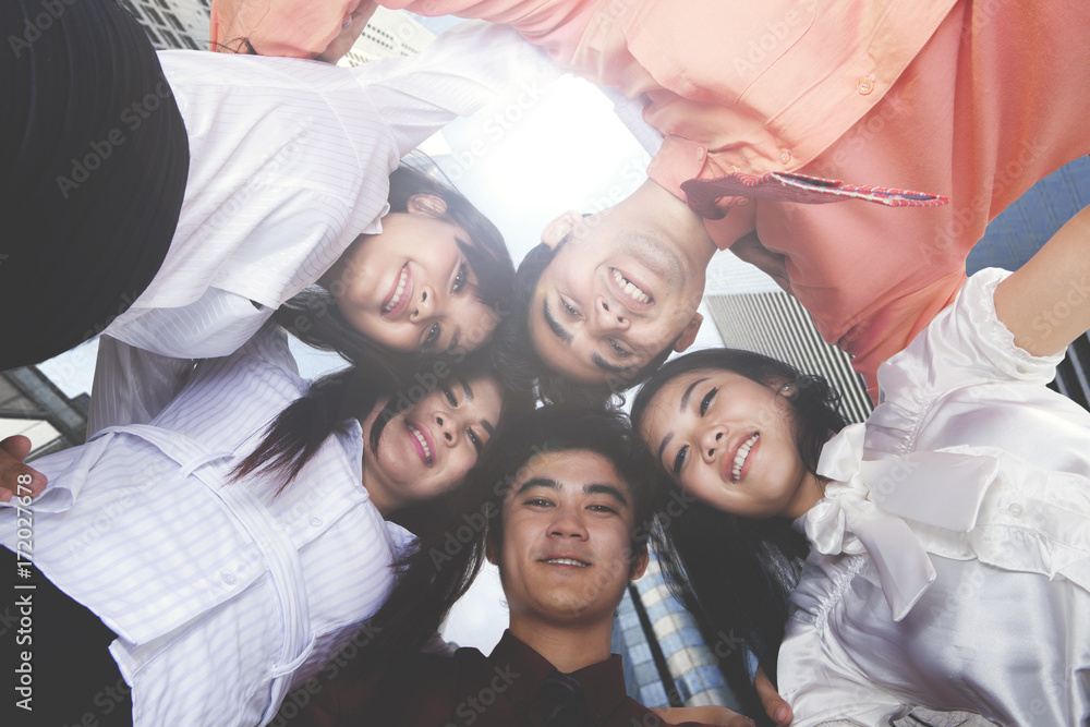 Happy business people embracing each other Happy business people embracing each other