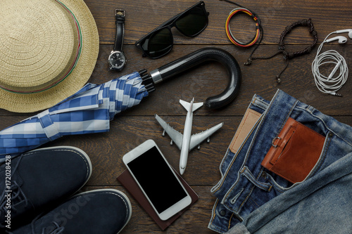 Overhead view of accessories fashion men clothing with technology concept background.Mix variety object on modern rustic wooden office desk.Essential items for teenage or adult and traveler to trip.