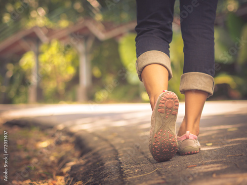 Closeup woman walking towards on the road side. Step concept.