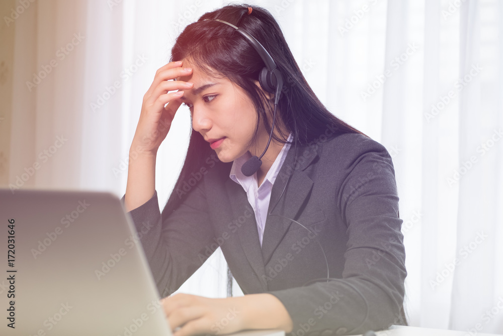 Beautiful young woman looking at a computer screen and thinking at the office, stressed and nervous Beautiful young woman looking at a computer screen and thinking at the office, stressed and nervous