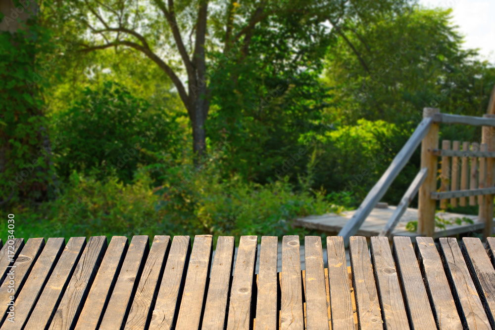 wooden table on a background of the summer country landscape.