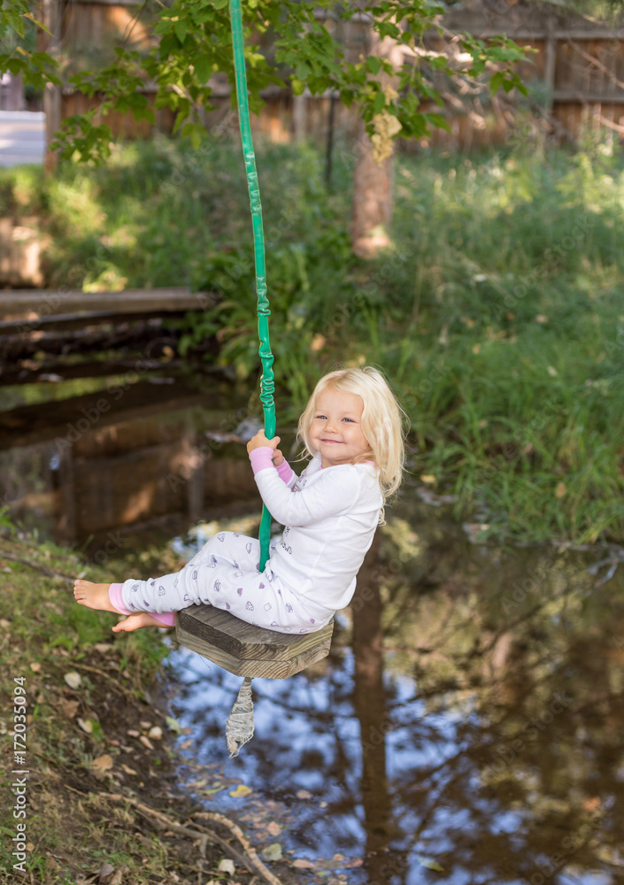 happy child on tree swing
