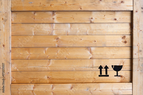Real wooden crate panel with black fragile icons