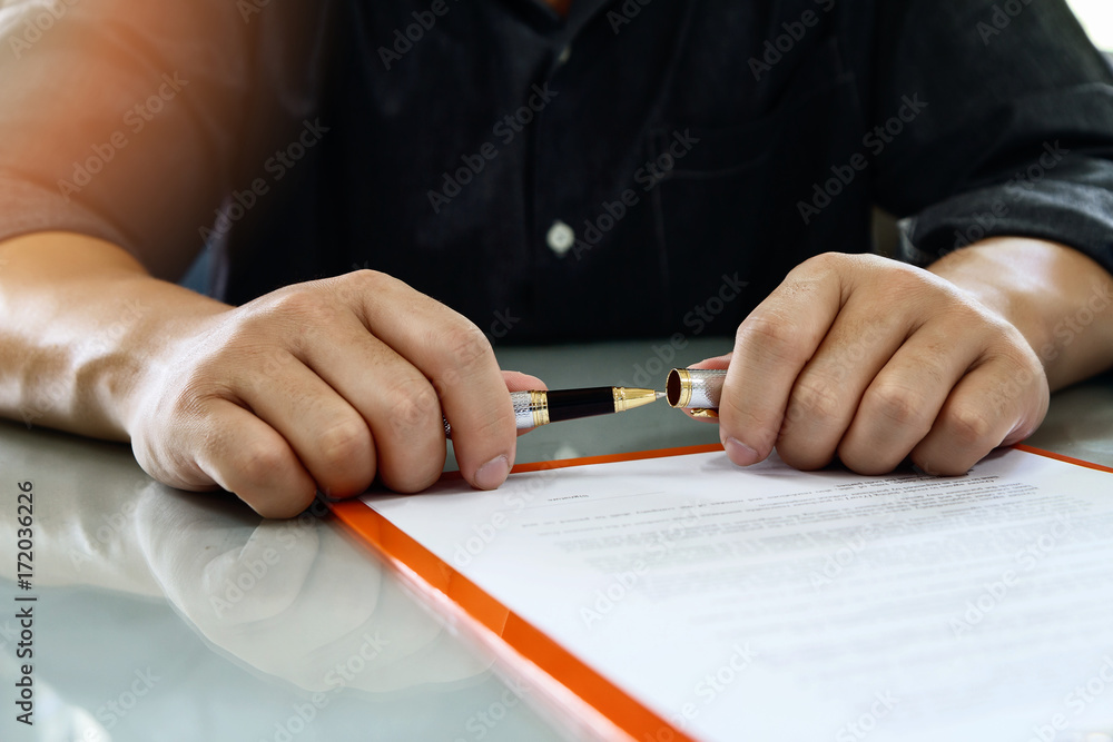 Close up of business man signing contract making a deal, business contract details. Businessman signing an official document Close up of business man signing contract making a deal, business contract details. Businessman signing an official document